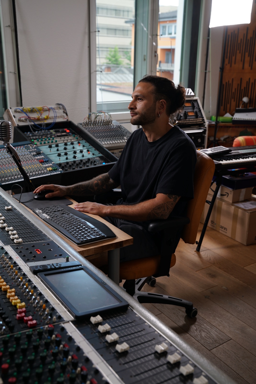 Engineer working on an analog mixing console