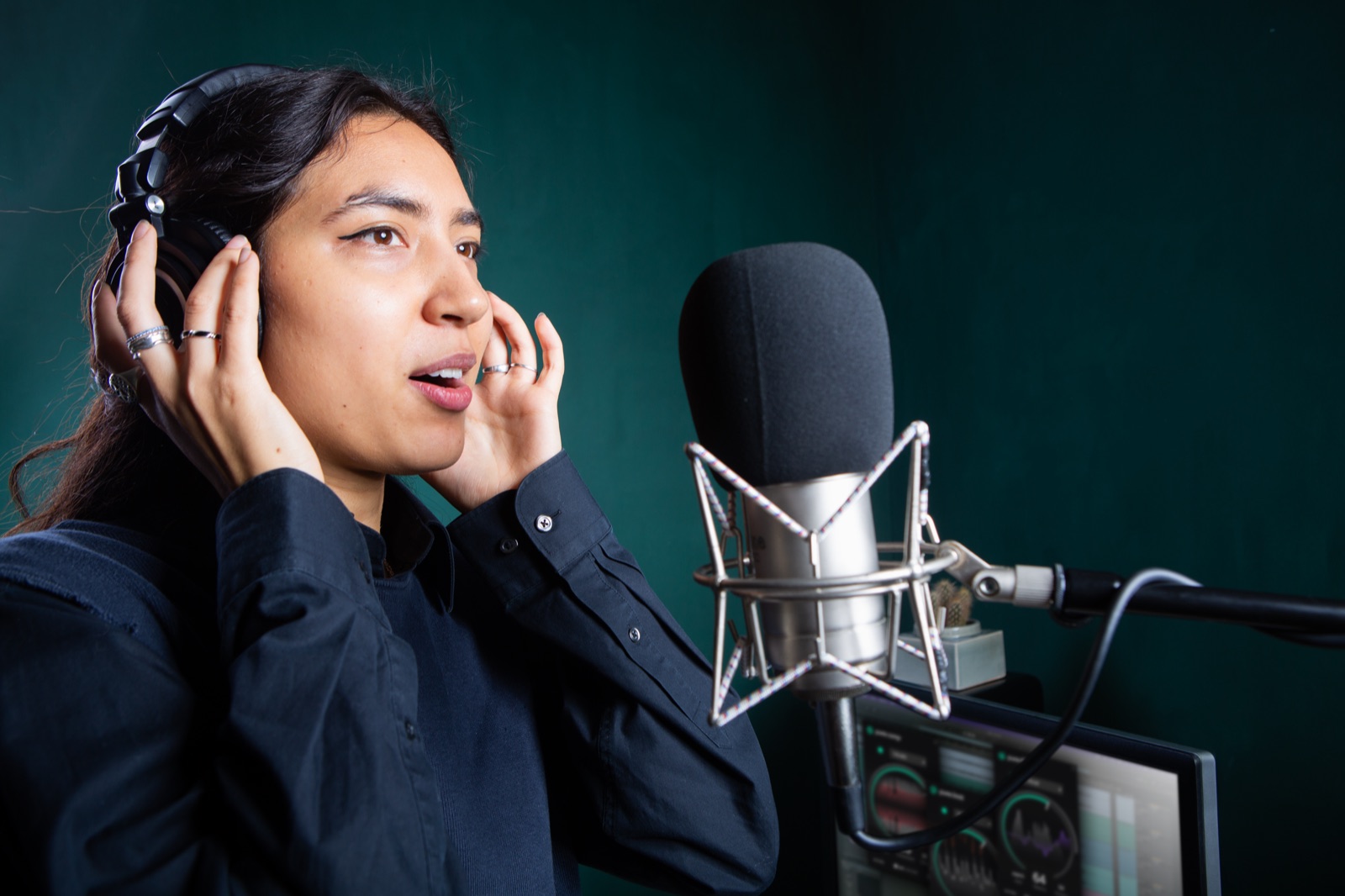 Vocalist singing into a studio microphone